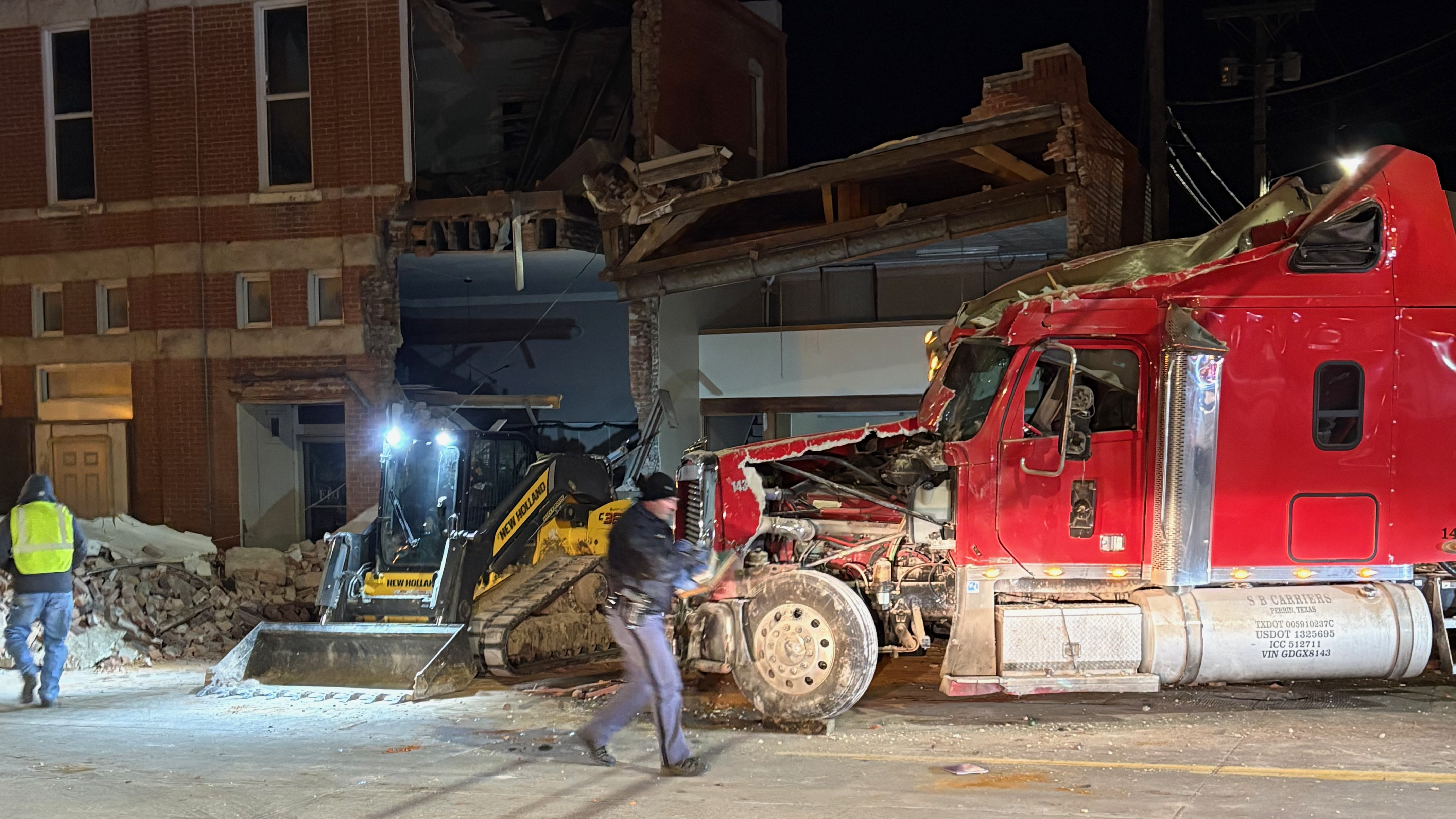 Semi crashes into downtown Auburn building