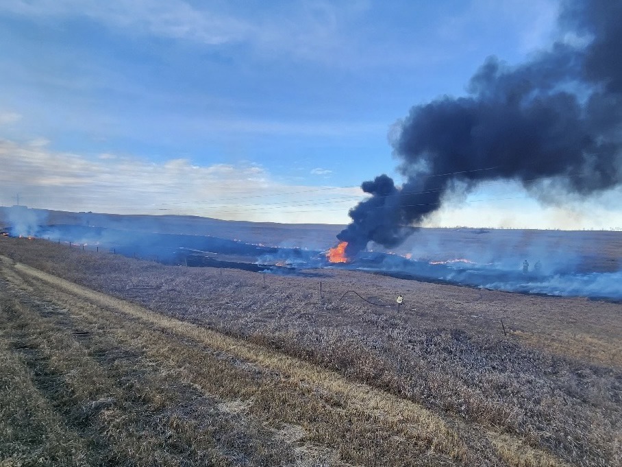 Person rescued from burning vehicle after crash sparks grass fire near Mission